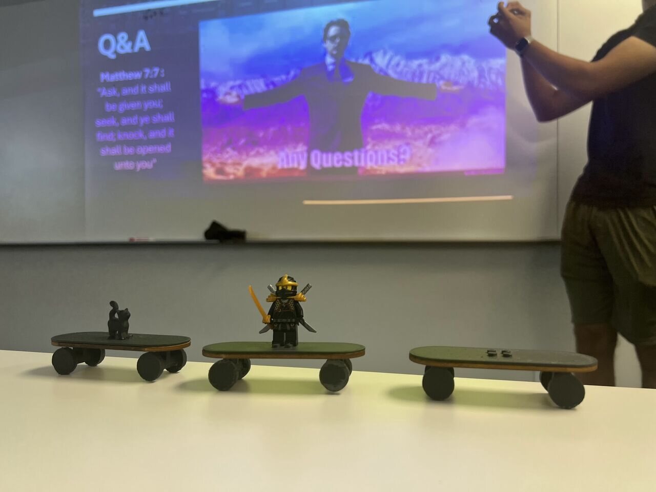 Student-designed skateboard prototypes displayed during a CAD presentation