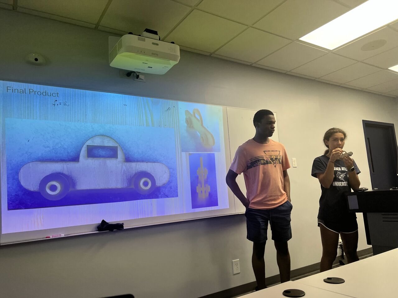 Students presenting a fabricated model vehicle